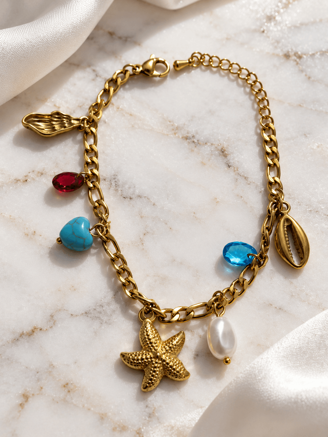 Ocean charm bracelet laid flat on marble