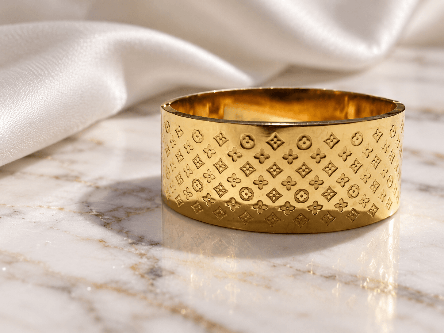Wide monogram gold kada on white marble